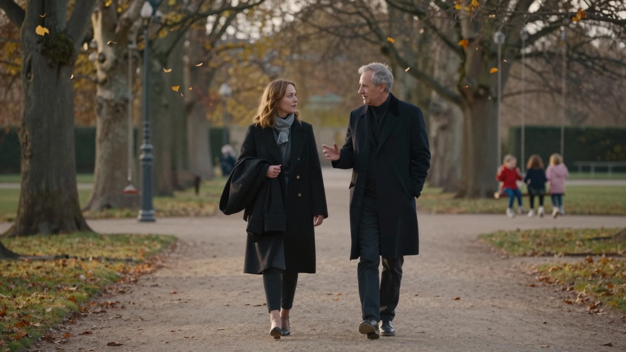 Two people walking peacefully through Luxembourg Gardens in autumn, leaves falling around them.